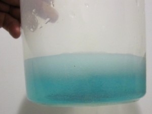 The homemade etchant quickly turns blue